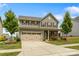 Inviting two-story home boasts a well-manicured lawn and an attached two-car garage at 7263 Waterwheel Sw St, Concord, NC 28025
