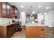 Modern kitchen with stainless steel appliances, granite counters, and wood cabinets at 7263 Waterwheel Sw St, Concord, NC 28025