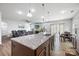 Modern kitchen island featuring granite countertops and pendant lighting at 7263 Waterwheel Sw St, Concord, NC 28025