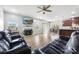 Spacious living room featuring a fireplace, ceiling fan and hardwood floors at 7263 Waterwheel Sw St, Concord, NC 28025