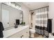 Modern bathroom featuring a white vanity, a black faucet, and a shower with a striped curtain at 7810 Leisure Ln, Huntersville, NC 28078