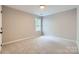 Neutral bedroom with carpet, window, and a minimalist design for a calming atmosphere at 7810 Leisure Ln, Huntersville, NC 28078