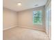 Simple bedroom with carpet, double door closet, and a window providing natural light at 7810 Leisure Ln, Huntersville, NC 28078