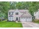 Beautiful two-story house with a well-maintained front lawn and attached two-car garage at 7810 Leisure Ln, Huntersville, NC 28078