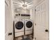 Well-lit laundry room features modern appliances, storage shelves, and stylish light fixture at 7810 Leisure Ln, Huntersville, NC 28078