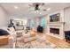 Inviting living room featuring a fireplace, hardwood floors, and abundant natural light at 7810 Leisure Ln, Huntersville, NC 28078