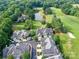 Aerial view of the neighborhood and golf course community with mature trees and pond at 8026 Greenview Terrace Ct, Charlotte, NC 28277