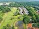 Stunning aerial view of a home situated on a golf course with access to Raintree Country Club at 8026 Greenview Terrace Ct, Charlotte, NC 28277