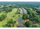 Wonderful aerial view of a home on a lush golf course and a serene pond, providing picturesque views at 8026 Greenview Terrace Ct, Charlotte, NC 28277