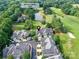 Aerial view of the neighborhood and golf course community with mature trees and pond at 8026 Greenview Terrace Ct, Charlotte, NC 28277