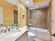 Bathroom with brown tile in shower/tub, with glass doors and a vanity with white marble top at 8026 Greenview Terrace Ct, Charlotte, NC 28277