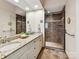 Bathroom featuring double vanity, granite countertops, and a tiled shower at 8026 Greenview Terrace Ct, Charlotte, NC 28277