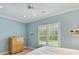 Light blue bedroom with white trim, ceiling fan, window with blinds, and a wood dresser at 8026 Greenview Terrace Ct, Charlotte, NC 28277