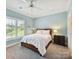 Cozy bedroom with shuttered window, offering ample natural light and comfort at 8026 Greenview Terrace Ct, Charlotte, NC 28277