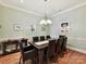 Elegant dining room with a dark wood table, stylish lighting, and sophisticated decor at 8026 Greenview Terrace Ct, Charlotte, NC 28277