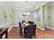 Charming dining room with hardwood floors and a stylish chandelier above the table at 8026 Greenview Terrace Ct, Charlotte, NC 28277