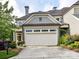 Charming exterior view of a home with a two-car garage and neatly trimmed landscaping at 8026 Greenview Terrace Ct, Charlotte, NC 28277