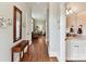 Bright hallway featuring hardwood floors and views into the adjacent living spaces and bath at 8026 Greenview Terrace Ct, Charlotte, NC 28277