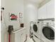 Laundry room with side-by-side washer and dryer and white cabinets for storage at 8026 Greenview Terrace Ct, Charlotte, NC 28277