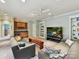 Inviting living room features comfortable seating, built-in shelving, and a convenient wet bar at 8026 Greenview Terrace Ct, Charlotte, NC 28277