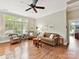 Inviting living room with hardwood floors and a large window offering plenty of sunlight at 8026 Greenview Terrace Ct, Charlotte, NC 28277