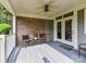 Covered patio with brick wall, ceiling fan, and French doors leading inside at 8026 Greenview Terrace Ct, Charlotte, NC 28277