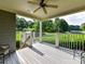 Covered back porch overlooking green space with a ceiling fan and white railings at 8026 Greenview Terrace Ct, Charlotte, NC 28277