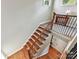 Bright staircase with hardwood steps, decorative iron railing, and windows bringing in natural light at 8026 Greenview Terrace Ct, Charlotte, NC 28277