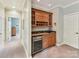 Well-appointed wet bar with granite countertop, ample storage, and convenient beverage refrigerator at 8026 Greenview Terrace Ct, Charlotte, NC 28277