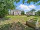 Spacious backyard with a lush lawn, mature trees, and a charming garden bed at 8304 Prescott Glen Pkwy, Waxhaw, NC 28173