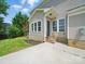 Back of home featuring a concrete patio, steps to yard, and exterior door at 8304 Prescott Glen Pkwy, Waxhaw, NC 28173