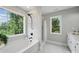 A bathroom with a large window next to the tub and a glass-enclosed shower, perfect for relaxation at 8304 Prescott Glen Pkwy, Waxhaw, NC 28173
