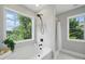 Bright bathroom with a large window next to the tub and a glass-enclosed shower at 8304 Prescott Glen Pkwy, Waxhaw, NC 28173