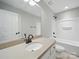 Clean bathroom with a single vanity, dark hardware, shower and bathtub combination, and a comfort height toilet at 8304 Prescott Glen Pkwy, Waxhaw, NC 28173