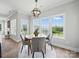 Cozy dining area with bright windows, a modern light fixture, and comfortable seating at 8304 Prescott Glen Pkwy, Waxhaw, NC 28173