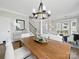 Dining room with staircase, decor, and bright windows leading into a living space at 8304 Prescott Glen Pkwy, Waxhaw, NC 28173