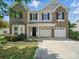 Charming two-story home with brick and siding, a two-car garage, and a well-maintained front yard at 8304 Prescott Glen Pkwy, Waxhaw, NC 28173