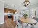 Open kitchen and dining area featuring wood cabinets, a breakfast bar, and stainless steel appliances at 8304 Prescott Glen Pkwy, Waxhaw, NC 28173