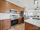 Modern kitchen featuring stainless steel appliances, white subway tile, and dark wood cabinets at 8304 Prescott Glen Pkwy, Waxhaw, NC 28173