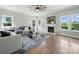 Bright living room with hardwood floors, modern ceiling fan and a fireplace with built-in shelving at 8304 Prescott Glen Pkwy, Waxhaw, NC 28173