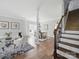 Inviting living room with hardwood floors, neutral paint, a dining area, and access to the staircase at 8304 Prescott Glen Pkwy, Waxhaw, NC 28173