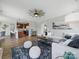 Open-concept living room with a plush gray sofa, adjacent to the kitchen with bar seating at 8304 Prescott Glen Pkwy, Waxhaw, NC 28173