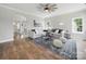 Bright living room featuring a comfortable gray sectional sofa and stylish ceiling fan at 8304 Prescott Glen Pkwy, Waxhaw, NC 28173