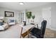 Bright office space with neutral walls, desk, chair, and decorated with tasteful home decor and a nice mirror at 8304 Prescott Glen Pkwy, Waxhaw, NC 28173