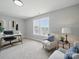Comfortable and well-lit office with desk, chair, windows, and a comfortable chair and side table at 8304 Prescott Glen Pkwy, Waxhaw, NC 28173