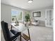 Bright office space featuring two chairs, a desk, large mirror and natural light coming in from the window at 8304 Prescott Glen Pkwy, Waxhaw, NC 28173
