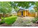 Cozy backyard with wooden fence, well-maintained lawn, stone patio and mature trees at 904 Anderson St, Charlotte, NC 28205
