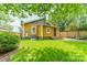 Backyard features a well-maintained lawn, a wooden fence, and an inviting stone patio at 904 Anderson St, Charlotte, NC 28205