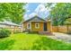 Lush backyard features a well-maintained lawn, wooden fence, and inviting stone patio at 904 Anderson St, Charlotte, NC 28205