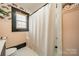 Nicely decorated bathroom showcasing shower with patterned walls and a window at 904 Anderson St, Charlotte, NC 28205